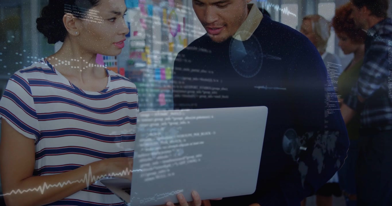 Woman typing on laptop man holding tablet causing holograms to appear across laptop for tech review