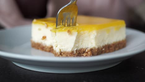 a piece of lemon cheesecake being eaten with a fork