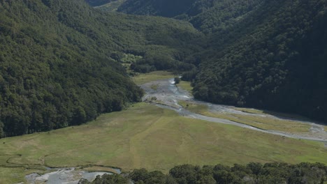 aerial view of a serene valley with a river running through it