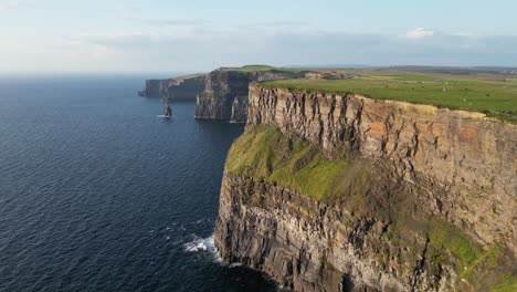 the cliffs of moher in ireland, showcasing the dramatic cliff faces against the atlantic ocean, aerial view