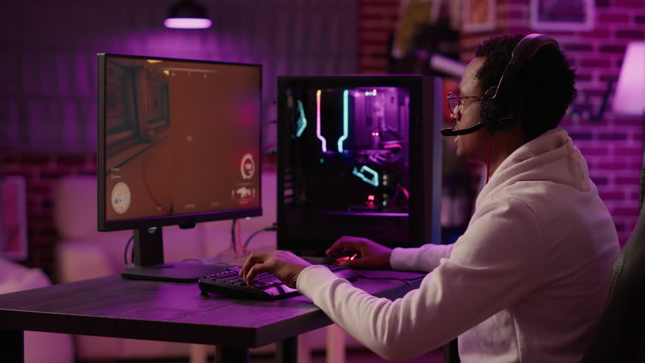 Handheld shot of african american man using pc gaming setup relaxing playing first person shooter