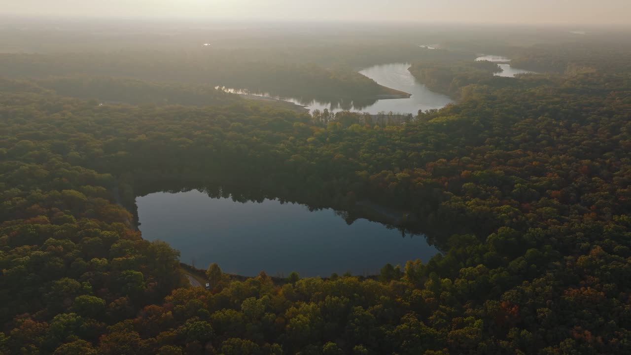 Aerial view of tranquil forests and river in Arkansas at sunrise