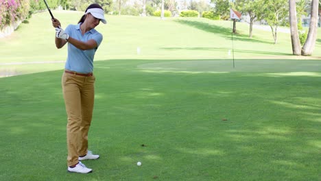 Woman-golfer-about-to-play-a-stroke-on-the-green