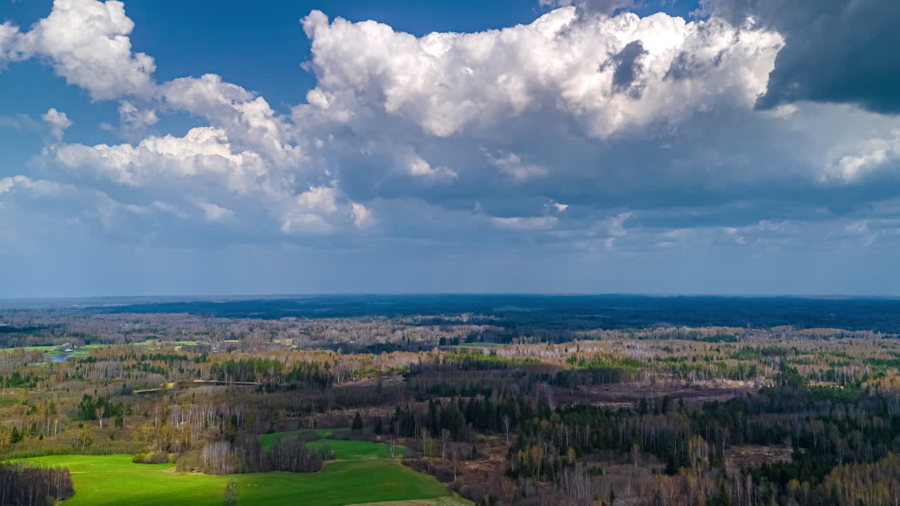 Timelapse time passing moving clouds over rural countryside forest evergreen tree