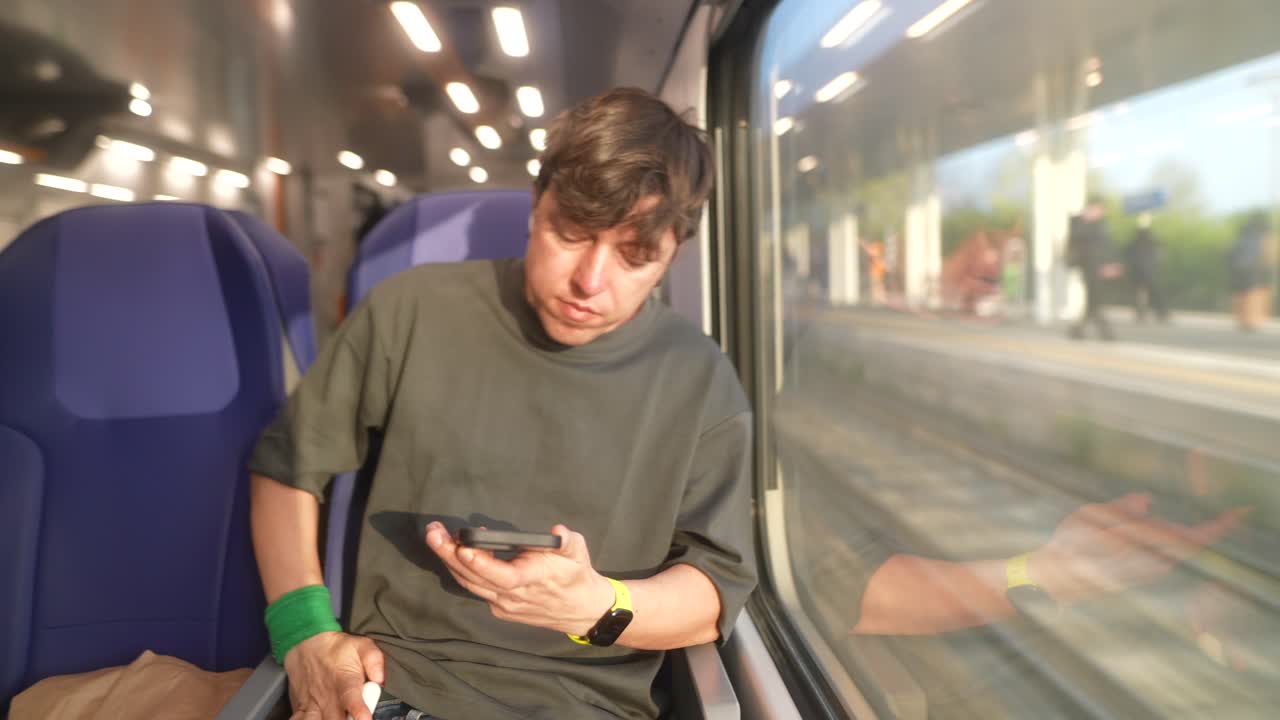 Man using mobile phone on a train