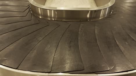 bags and suitcases move along conveyor belt in the baggage reclaim hall at the airport