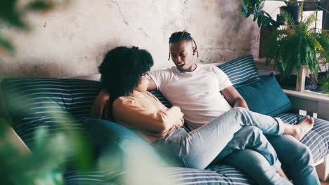 an affectionate couple relaxing on the couch