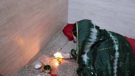 indian women doing holy rituals at home for children's wellbeing from different angle on the occasion of jitiya vrat or nirjala vrat in india