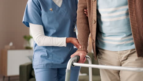 nurse assisting elderly patient with walker