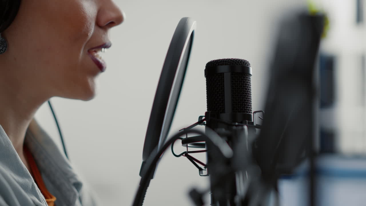 Internet live radio talk show host talking to audience at microphone
