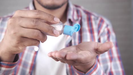 person applying hand sanitizer and washing hands