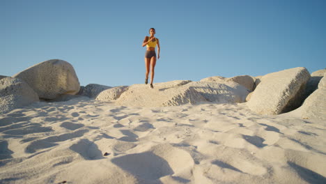 an active, fit and athletic woman running on beach