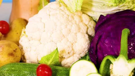 assorted vegetables arranged against a blue background