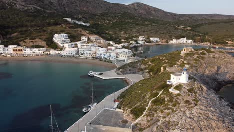 drone footage of kythira greek island beach, with white village houses in the background