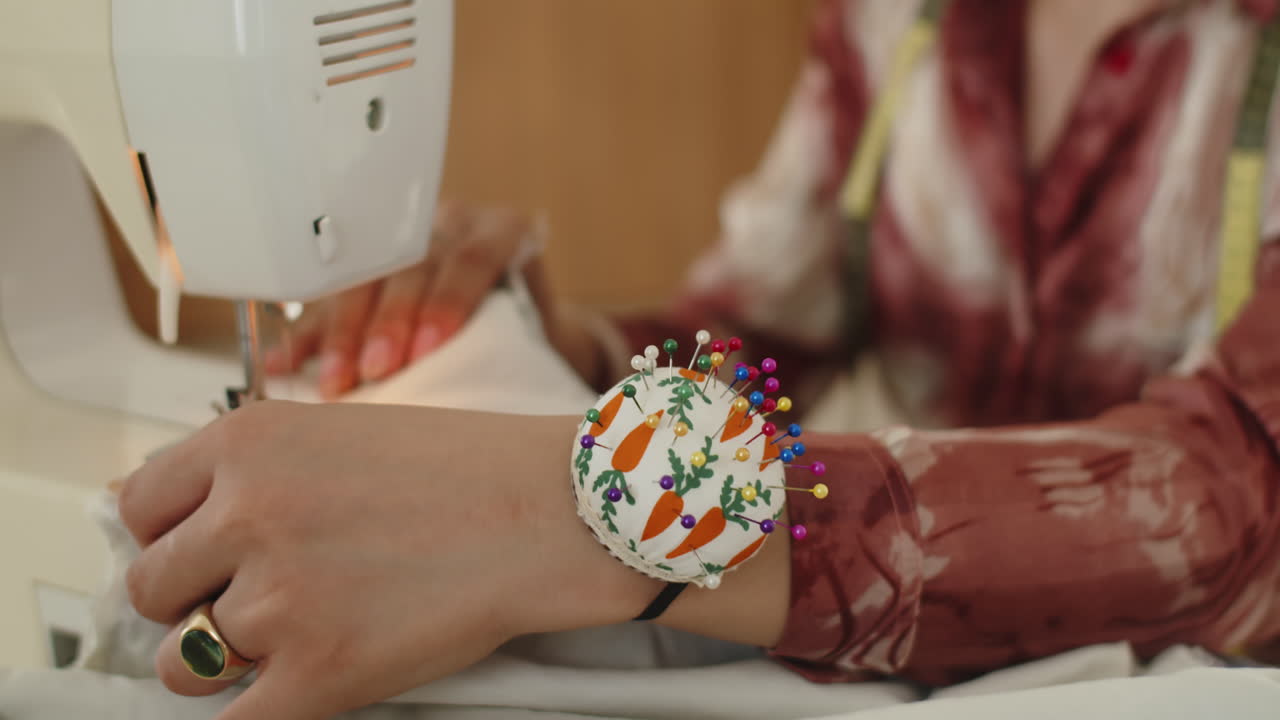 Female Tailor Using Sewing Machine at Studio