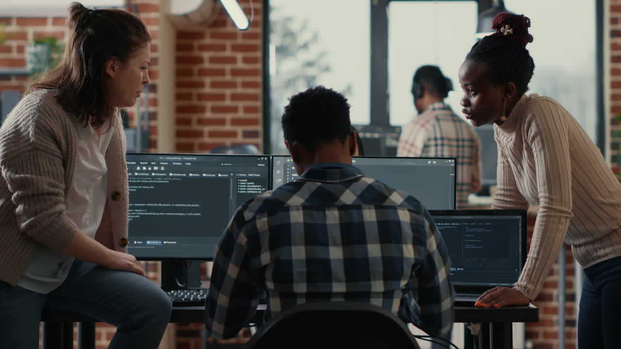 System engineer sitting on desk discussing with mixed team of coders about ai innovation