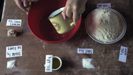 Brot-Backen-Mit-Etikettenzutatenrezept-über-Dem-Holztisch-Und-Die-Hand-Einer-Frau-Erscheinen-Zur-Arbeit