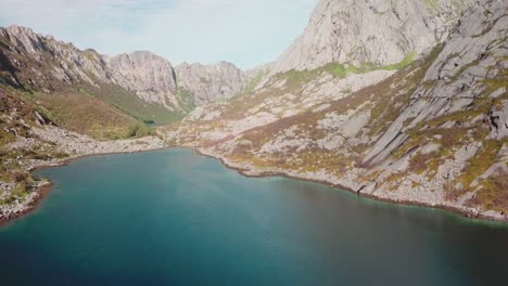 Forward-panning-drone-shot-over-the-sea-with-steep-rocky-cliffs-all-around