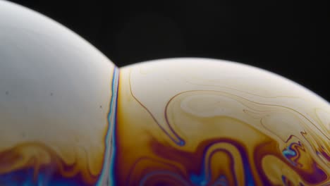 rainbow colors on soap bubble surface in macro shot macro of soap bubbles displaying vibrant rainbow colors on their surfaces the interplay of light creates a spectrum effect highlighting the delicate film structure