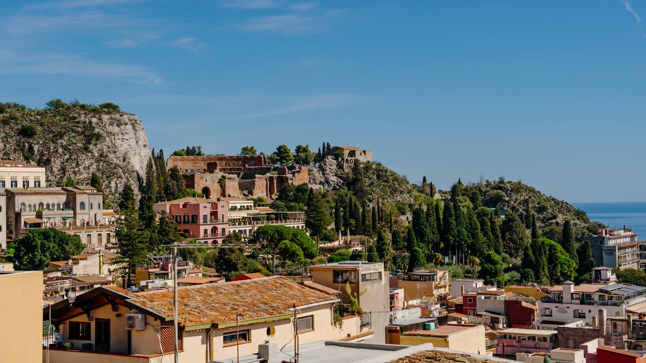 View to historic site of Taormina's ancient theater. Timelapse of a town in the mountains in Sicily.