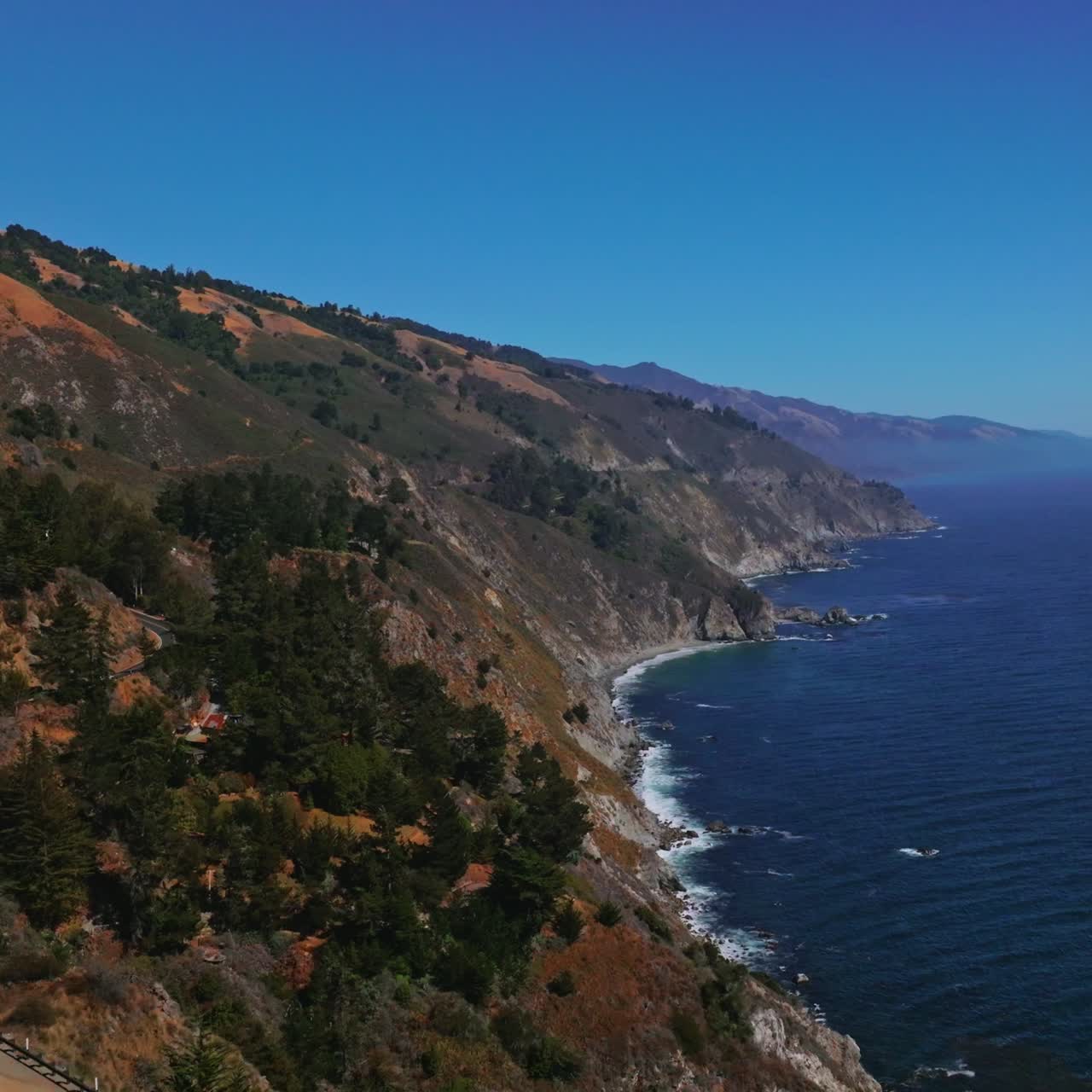 Splendid scenery of mountains meeting the ocean. Roads in the rocks among the pine trees. Big Sur Morro Bay in California, USA