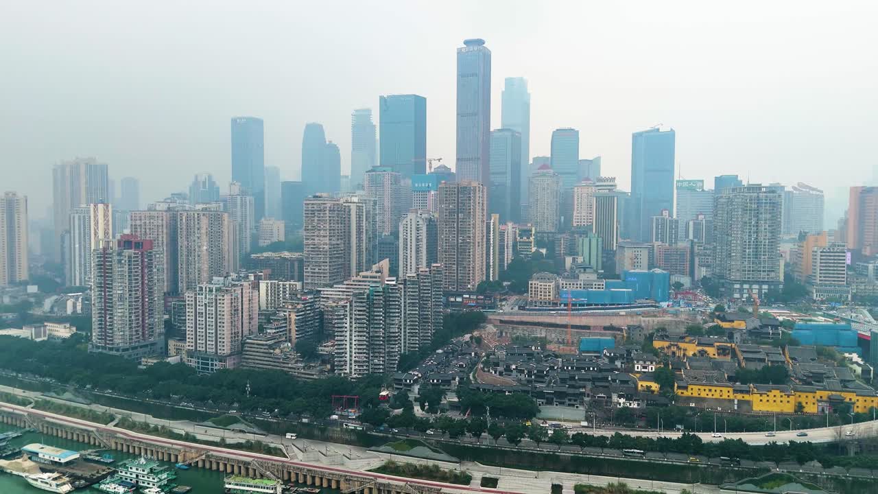 Aerial view of the sprawling cityscape of Chongqing, China, concept of towering skyscrapers, residential buildings, and the bustling urban environment along the river.