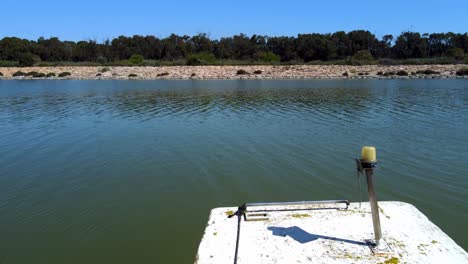 A-forgotten-old-boat-on-the-docks-along-the-Segura-River,-Spain