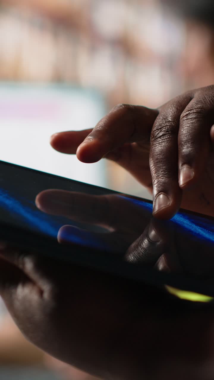 Vertical Video Close up of african american person checking tracking info for parcels on tablet