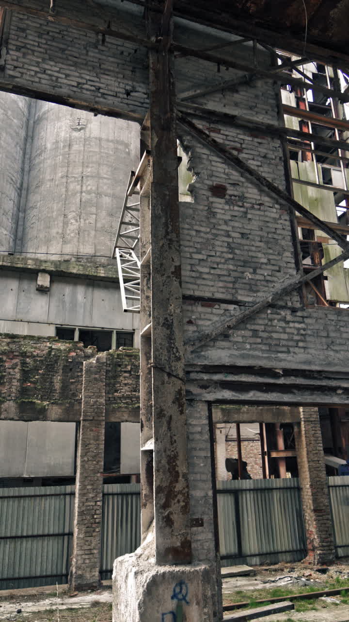 Inside ruined factory. Old industrial building for demolition. Vertical video