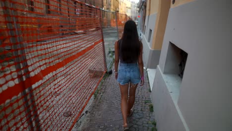 mujer caminando a través de una zona de construcción en una ciudad