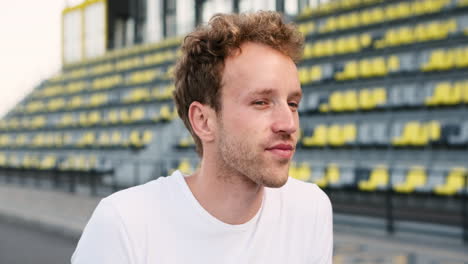 Close-Up-Of-A-Confident-Sportsman-Smiling-And-Looking-At-Something-In-A-Stadium