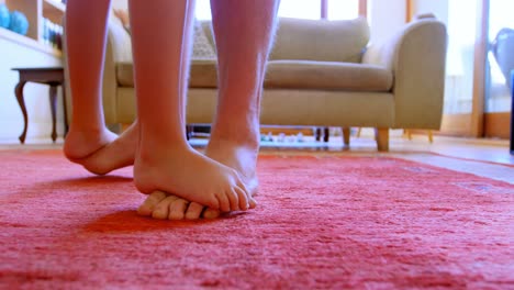 father and daughter dancing together in living room 4k