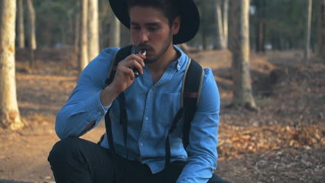 guy vaping in the woods