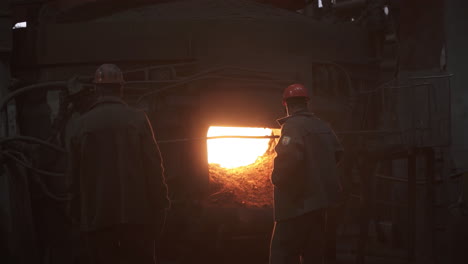 steel workers observing furnace