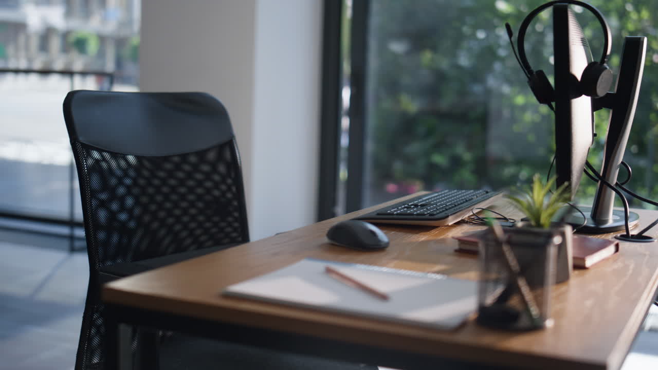 Empty workspace computer monitor and headphones on desk closeup. Modern office