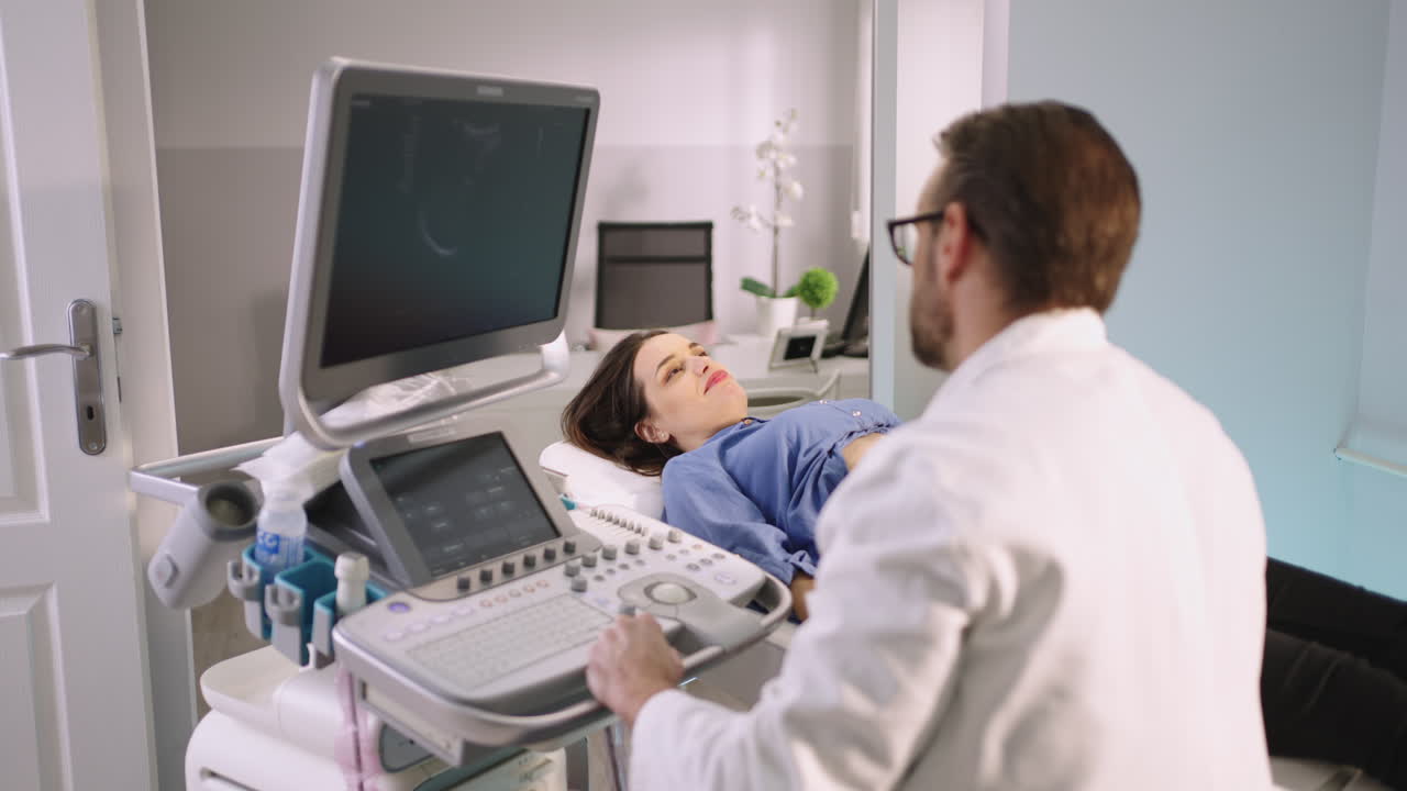 Doctor Performing Ultrasound Examination on Patient