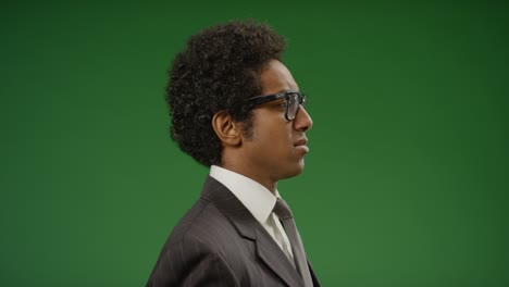 businessman puts on glasses and turns to camera