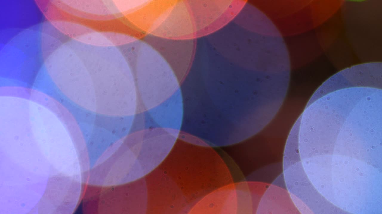 Christmas background . Blurry lights of a New Year's garland . Blue and orange colored bulbs flickering on a dark backdrop out of focus  50 fps 4k