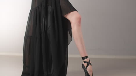 ballet dancer in black pointe shoes and dress
