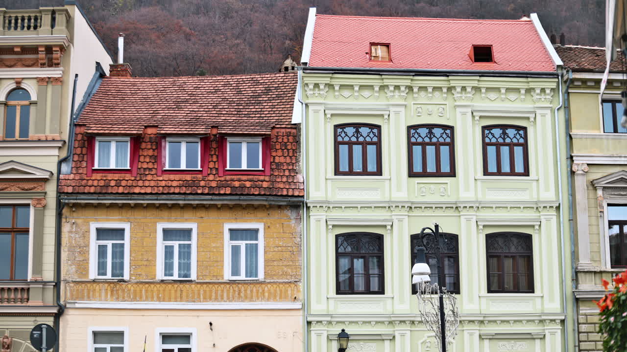 The facade of multiple, old style buildings in Brasov, Romania