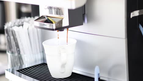 sequence of coffee being dispensed into a cup