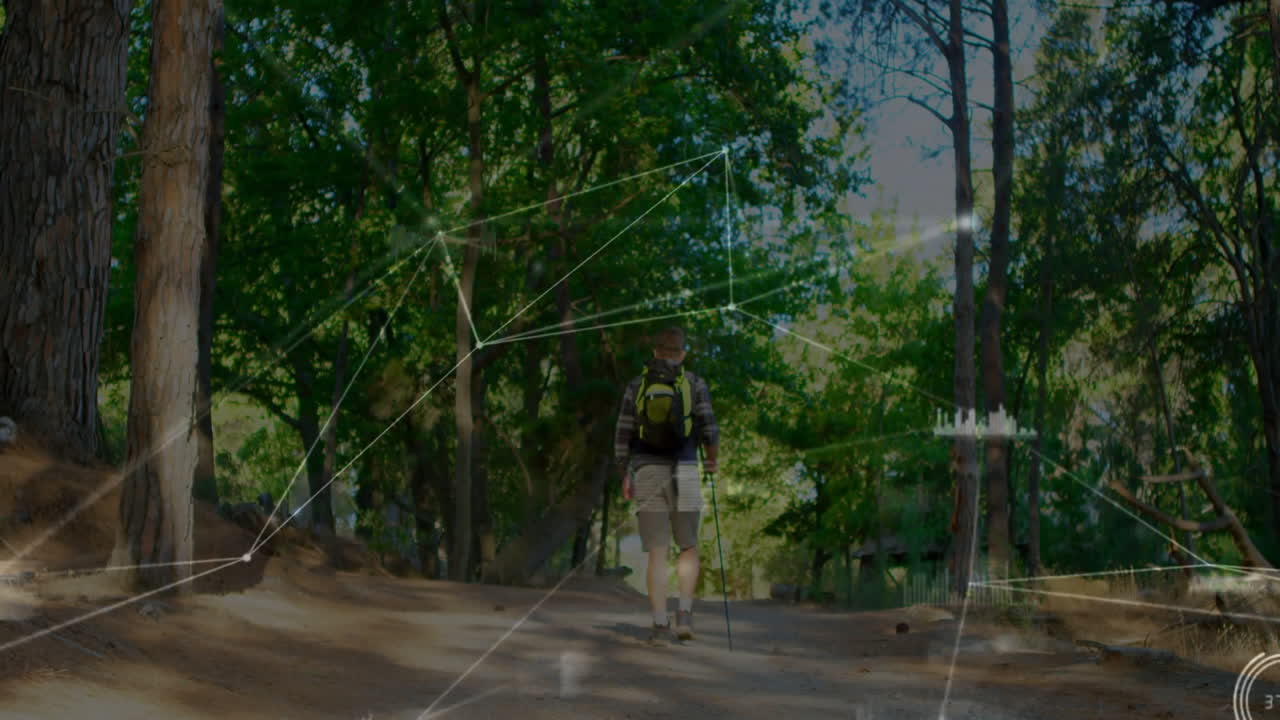Mature male hiker trekking through pine forest trail, showing augmented reality technology graphics