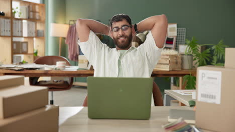 man relaxing at his desk in a home office setting