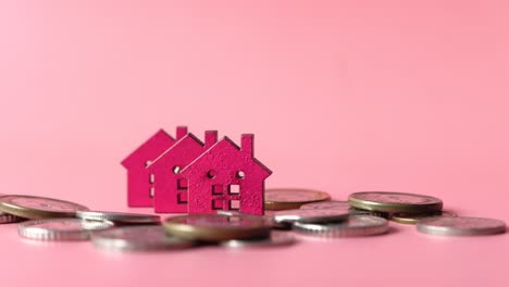 pink miniature houses and coins