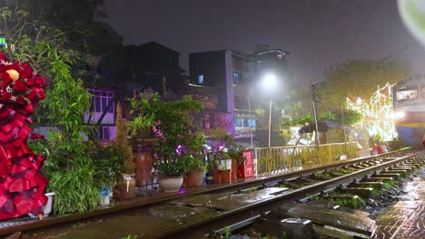 train moves through vibrant, plant-lined street