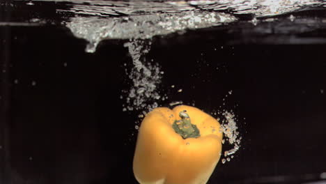 pepper falling into water in super slow motion