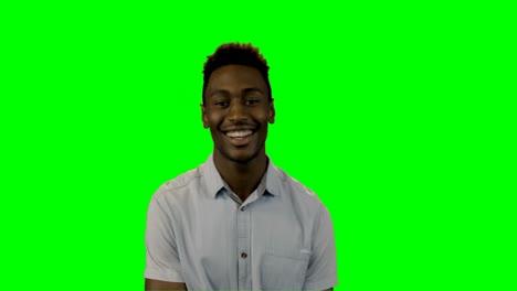 Smiling-man-standing-against-green-screen