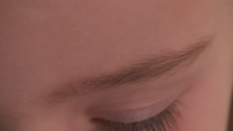 slow motion macro close up of a child's bright, blue eyes