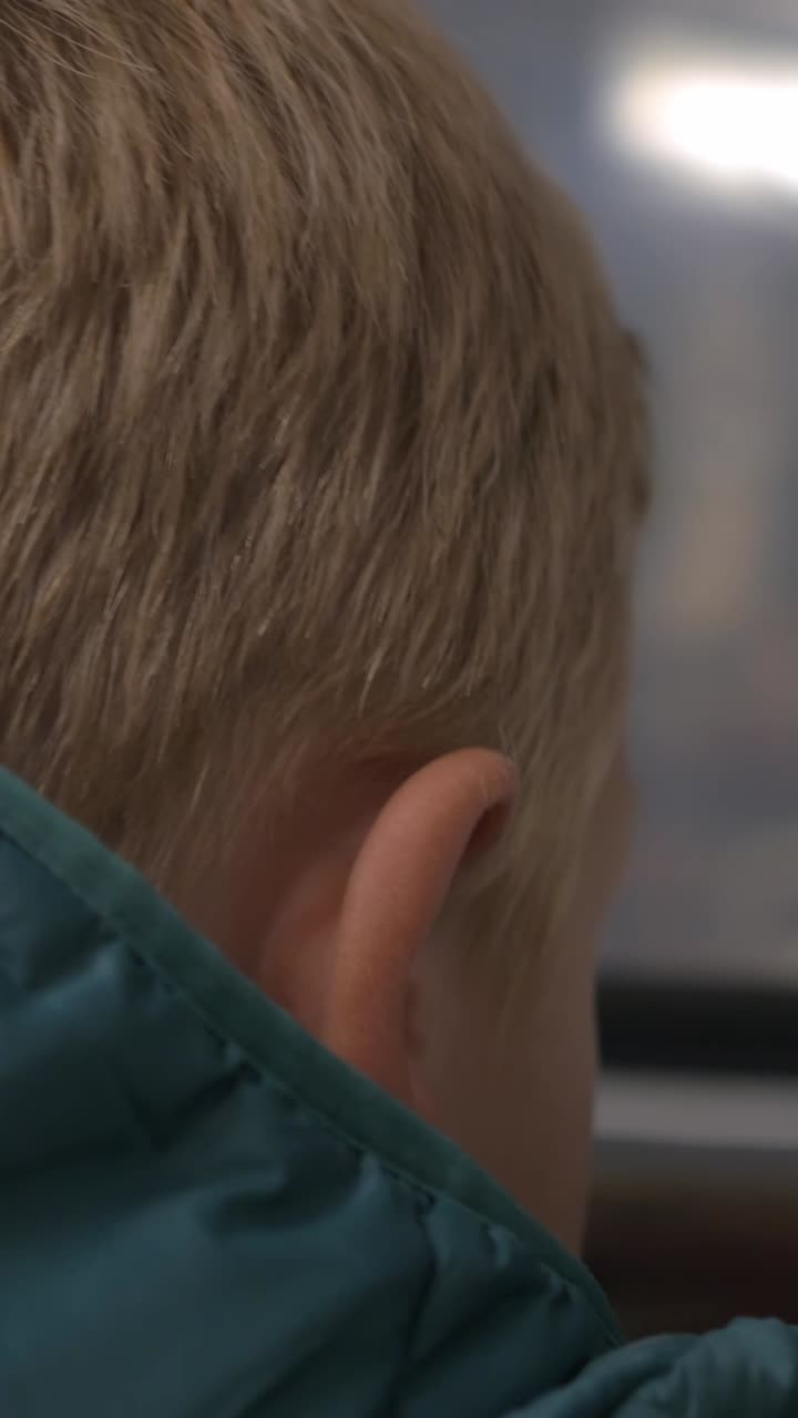 Back of Young Blonde Child's Head Looking Out