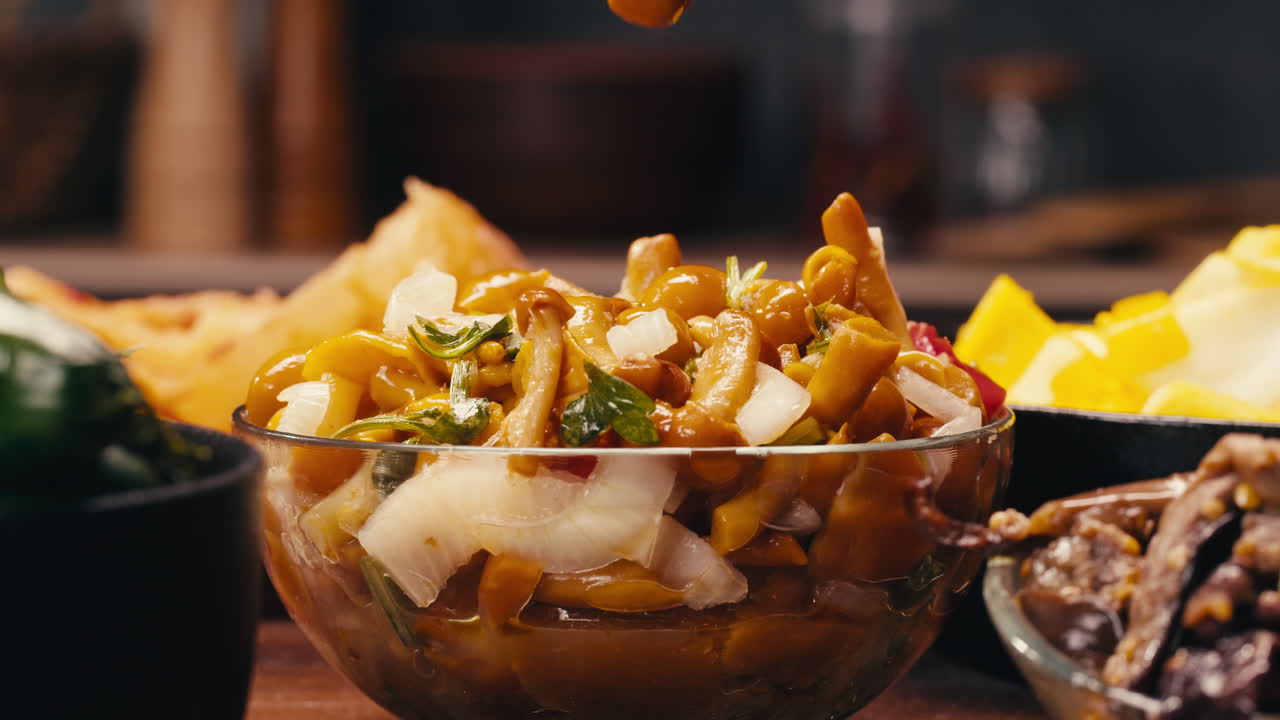 Taking a little bit of fermented yellow honeydew mushrooms with onion by chopsticks close-up. Preservation of vegetables in glass jars. Fermentation preserved mushroom with spices. Asian cuisine.